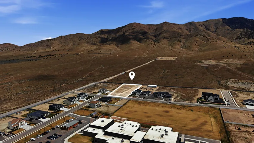 View of property location with a mountain backdrop and nearby suburban area