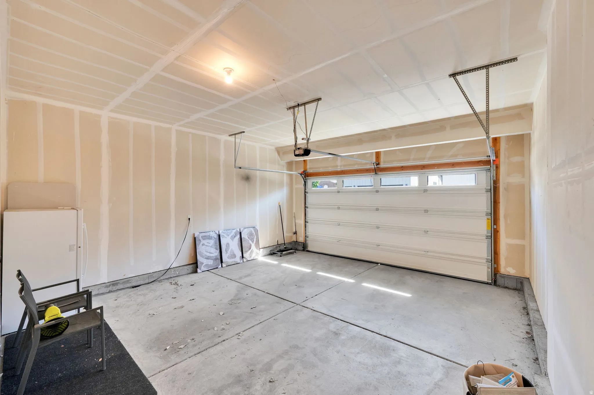 Garage featuring freestanding refrigerator