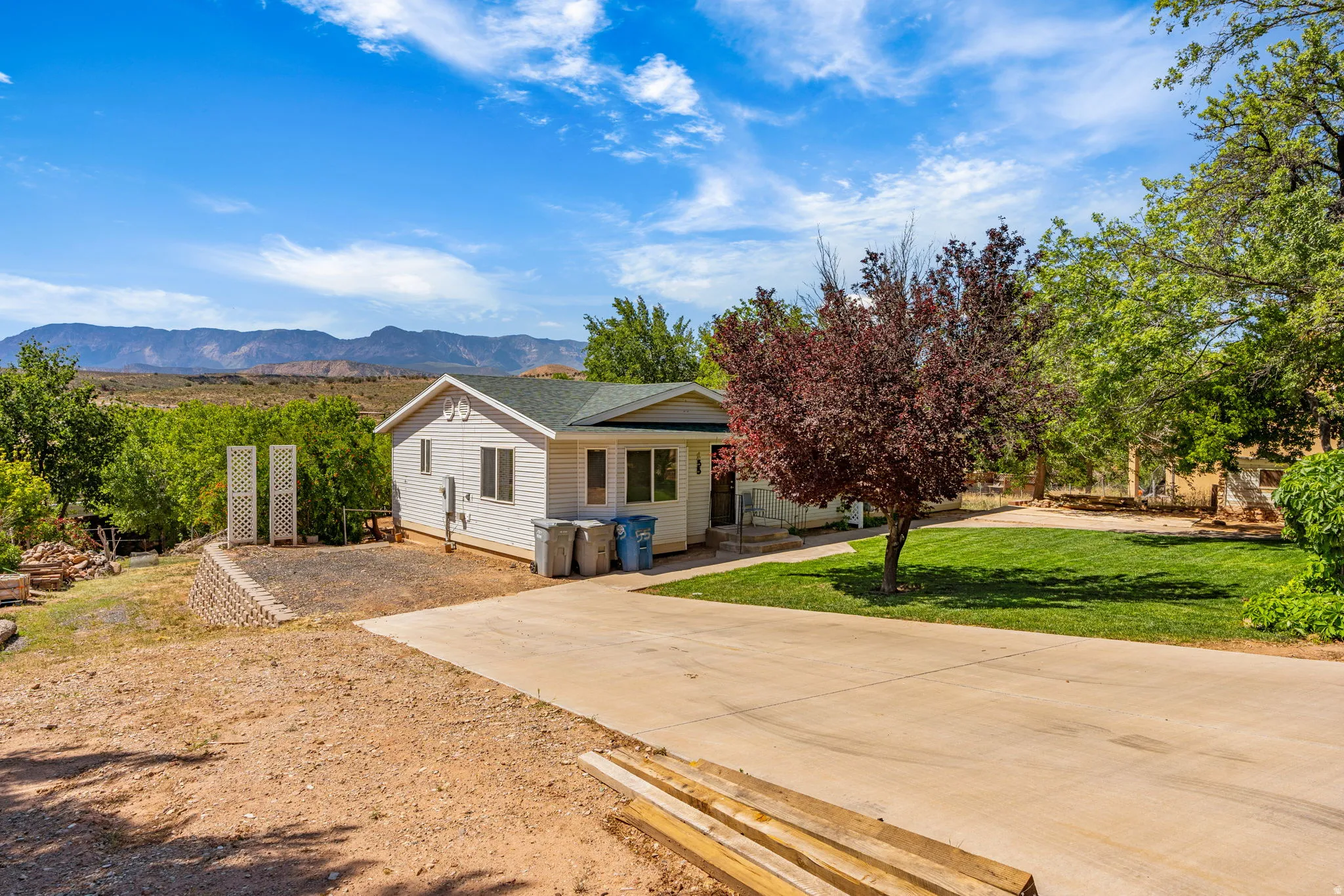 View of front of home with a front lawn and a mountain view