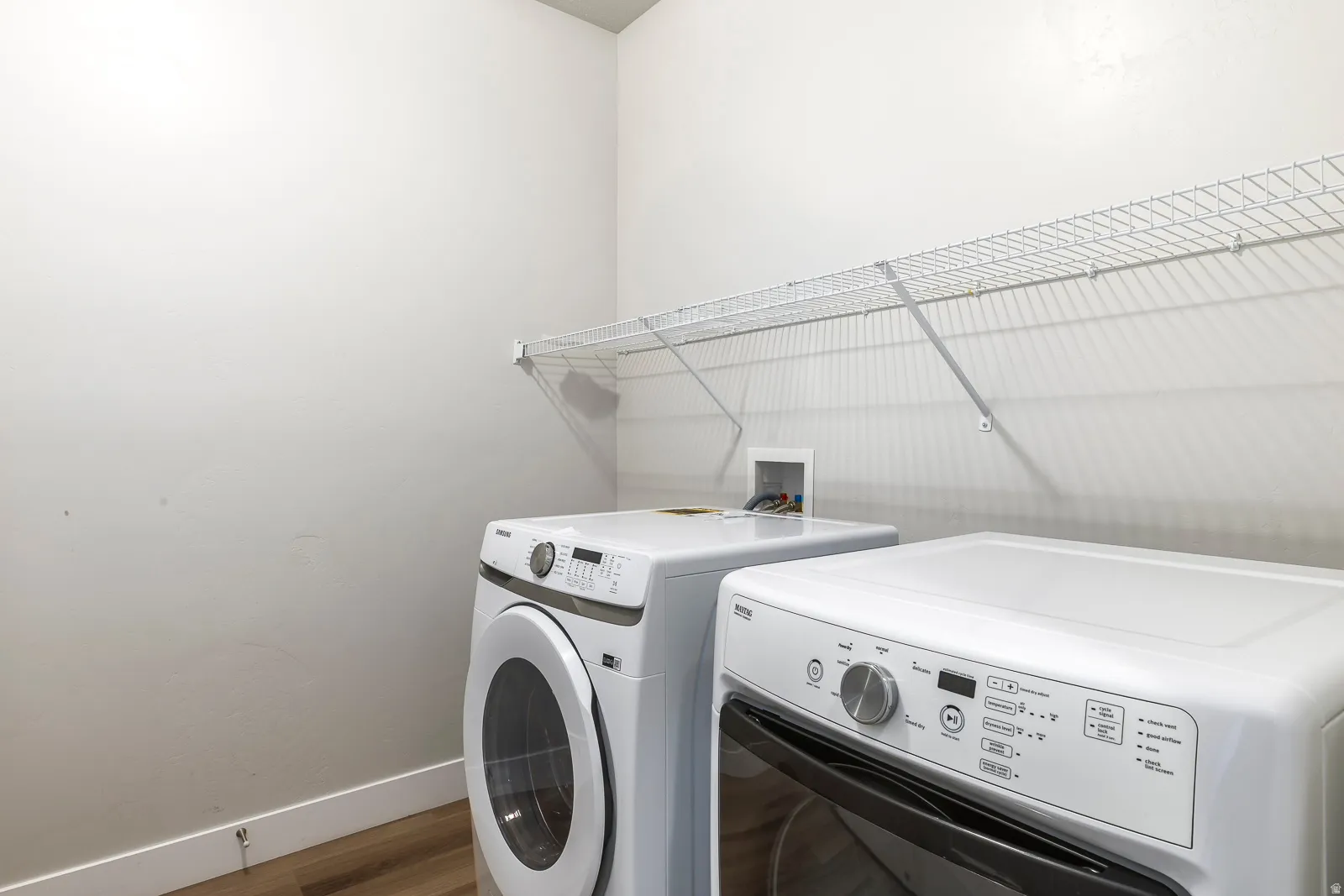Laundry room with independent washer and dryer and wood finished floors