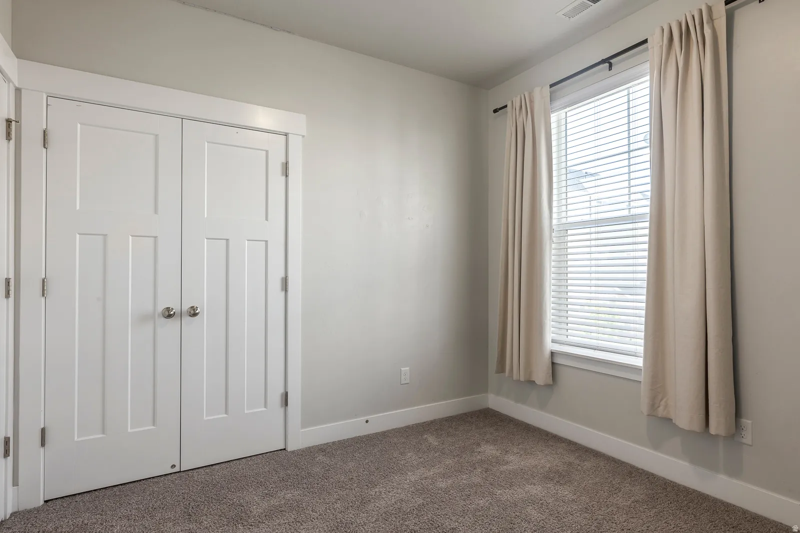 Unfurnished bedroom with a closet and carpet flooring