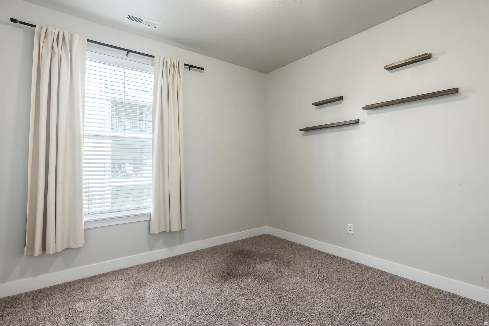 Unfurnished room featuring baseboards and carpet floors