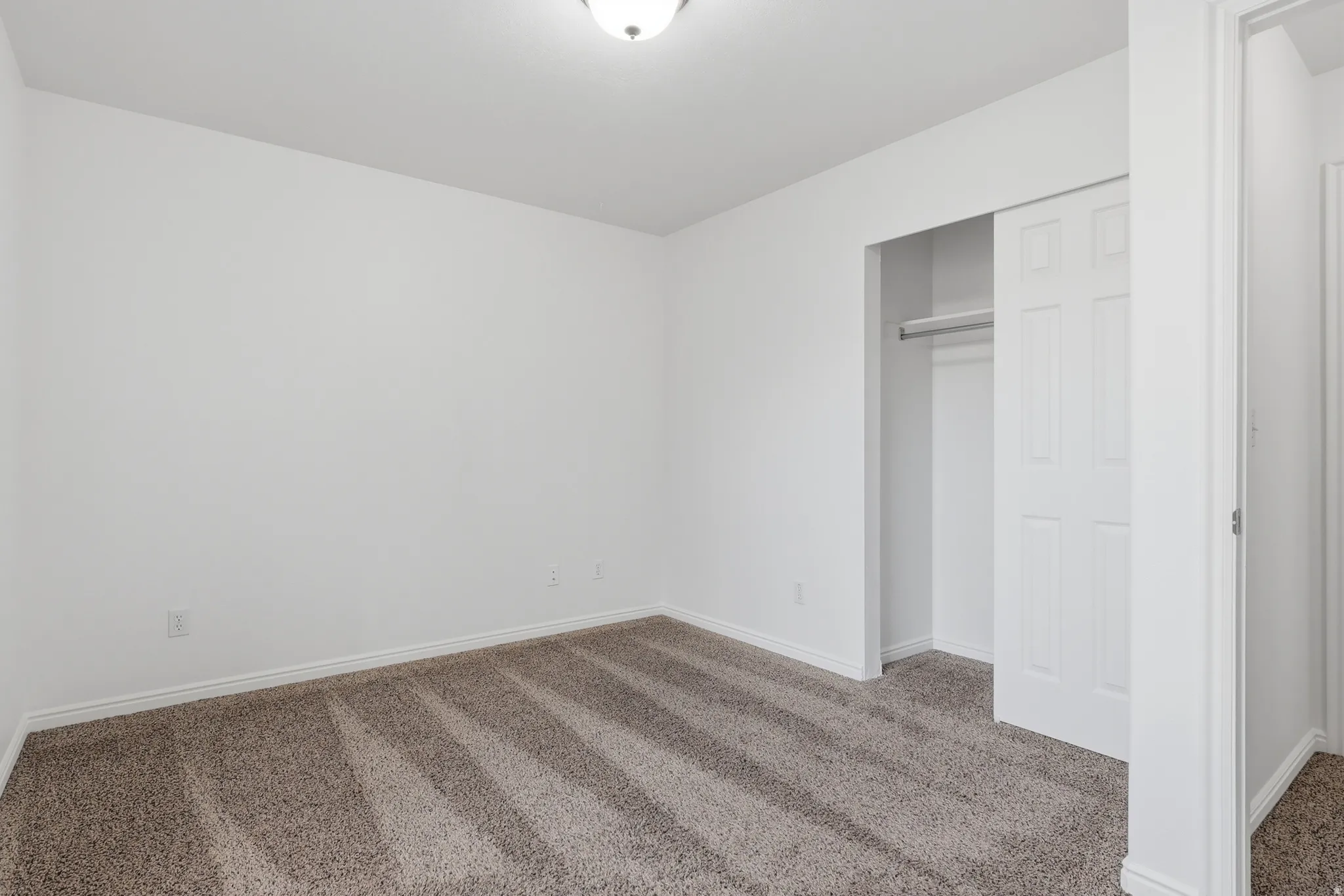 Unfurnished bedroom featuring carpet floors and a closet