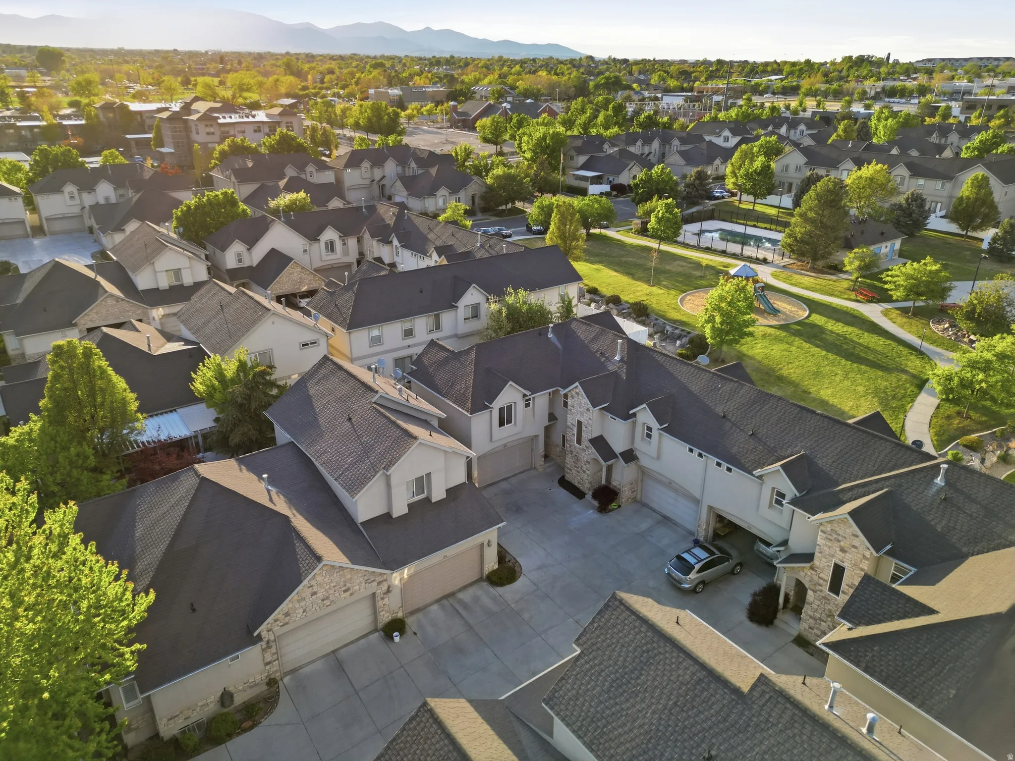 Aerial perspective of suburban area featuring a mountain backdrop