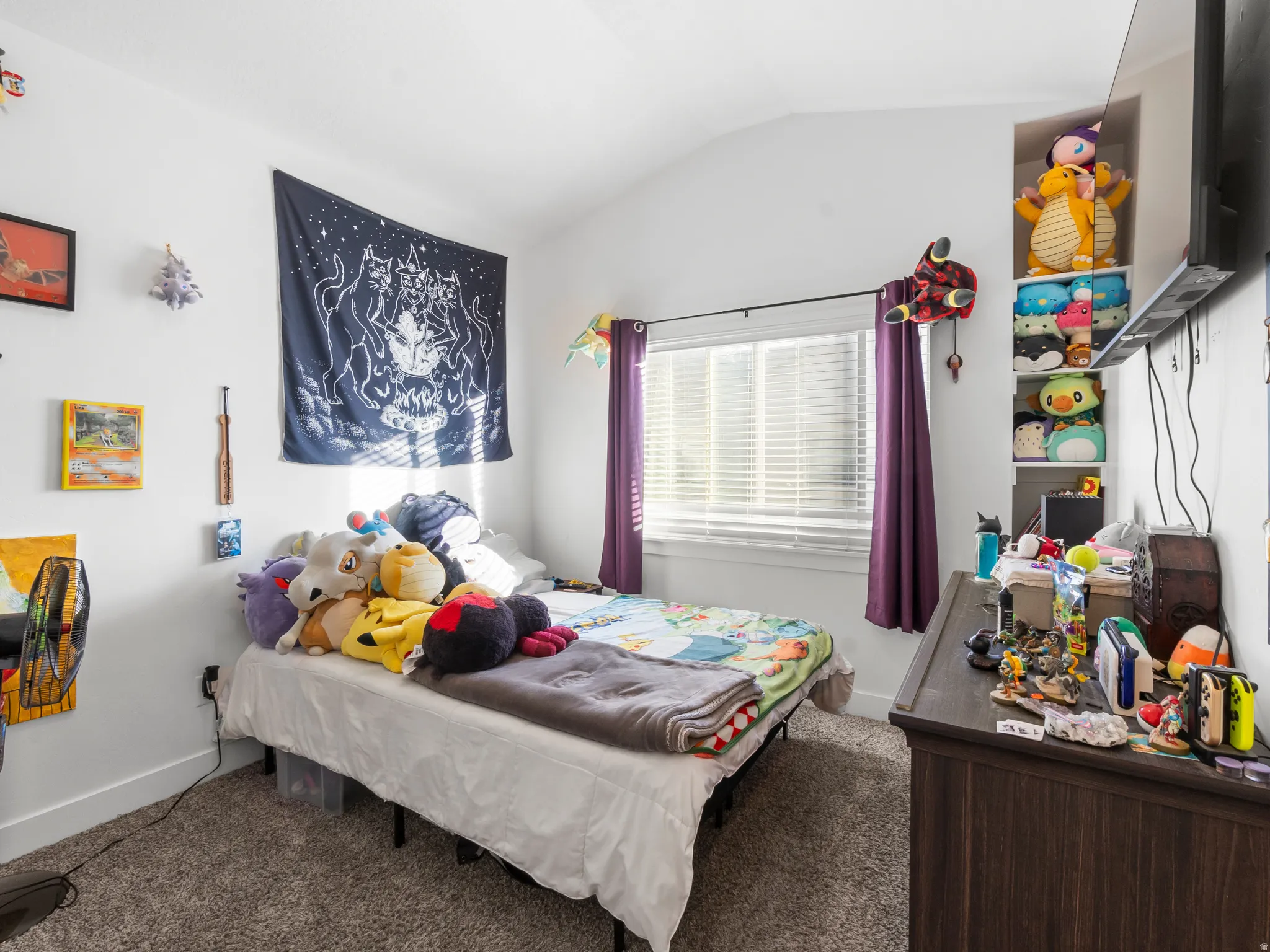 Bedroom with carpet floors and vaulted ceiling