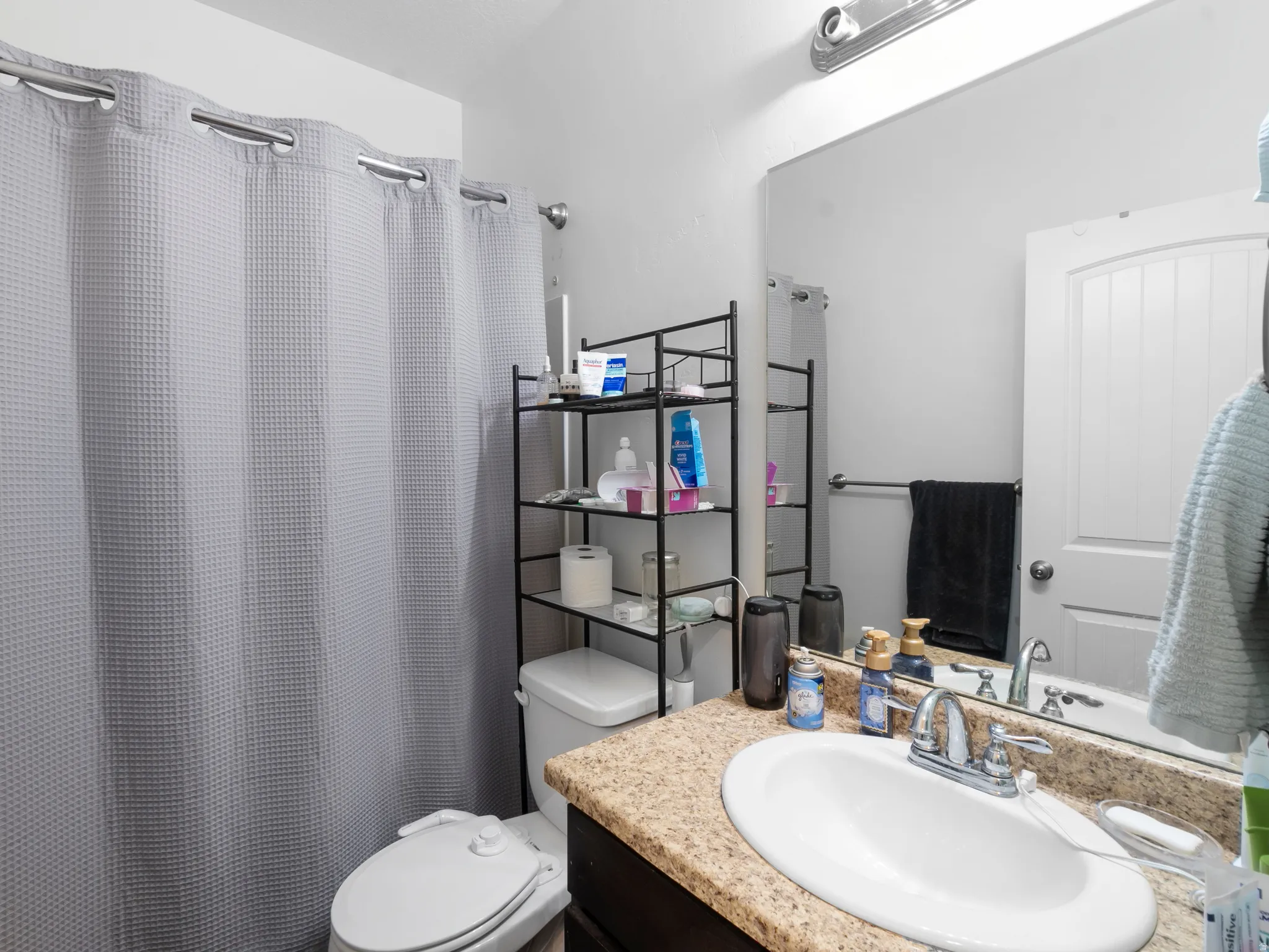 Full bath with vanity and curtained shower