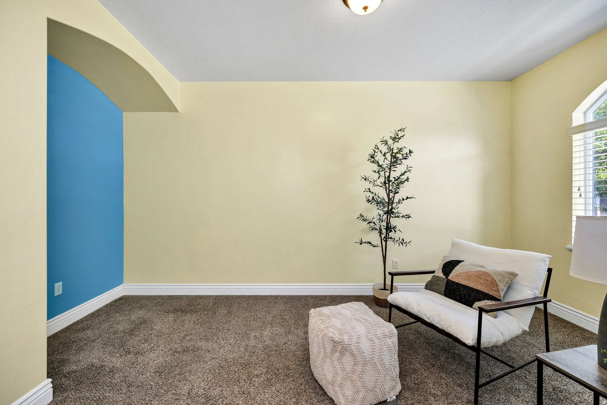 Front Living area featuring carpet flooring and arched walkways