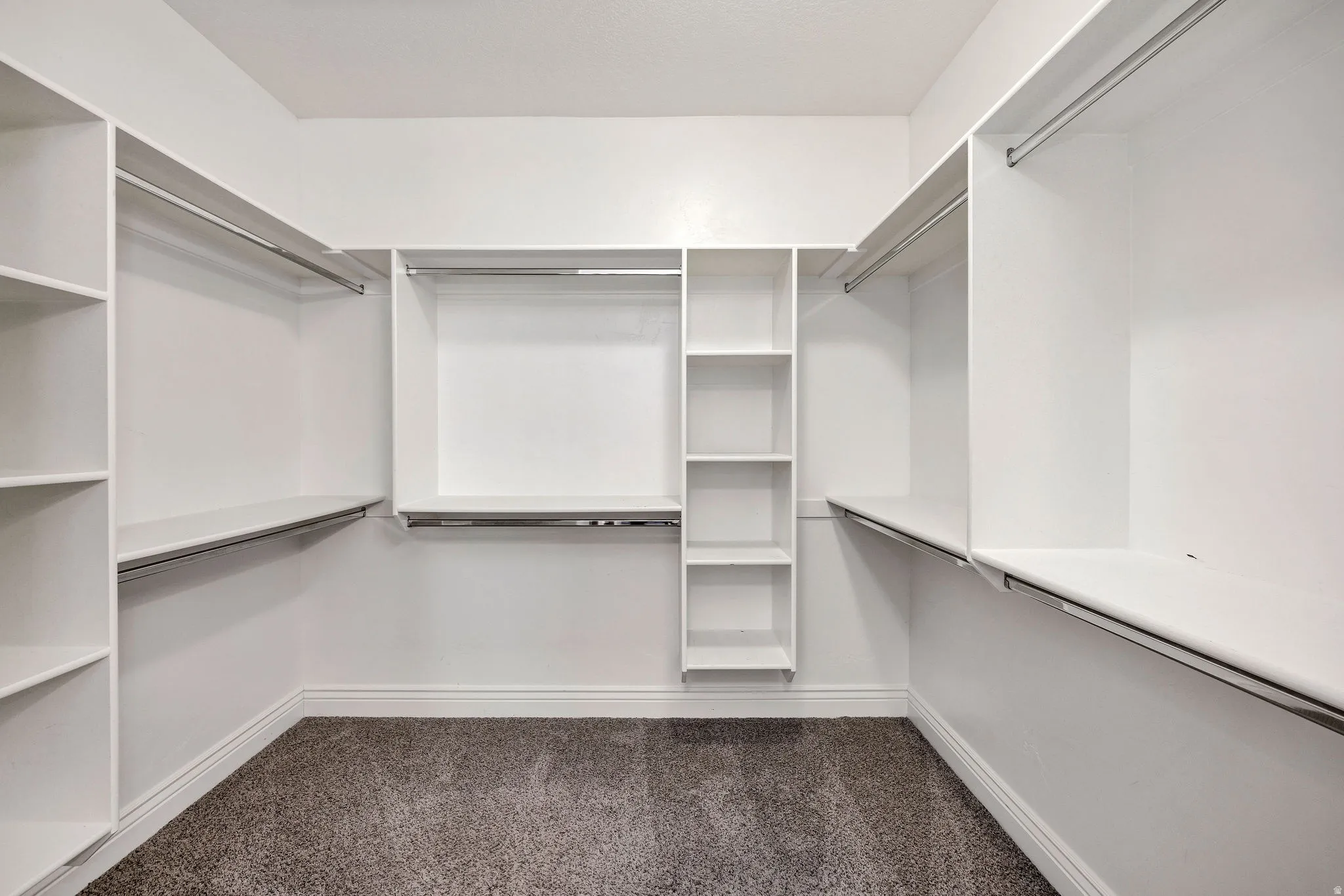 Walk in closet with dark carpet