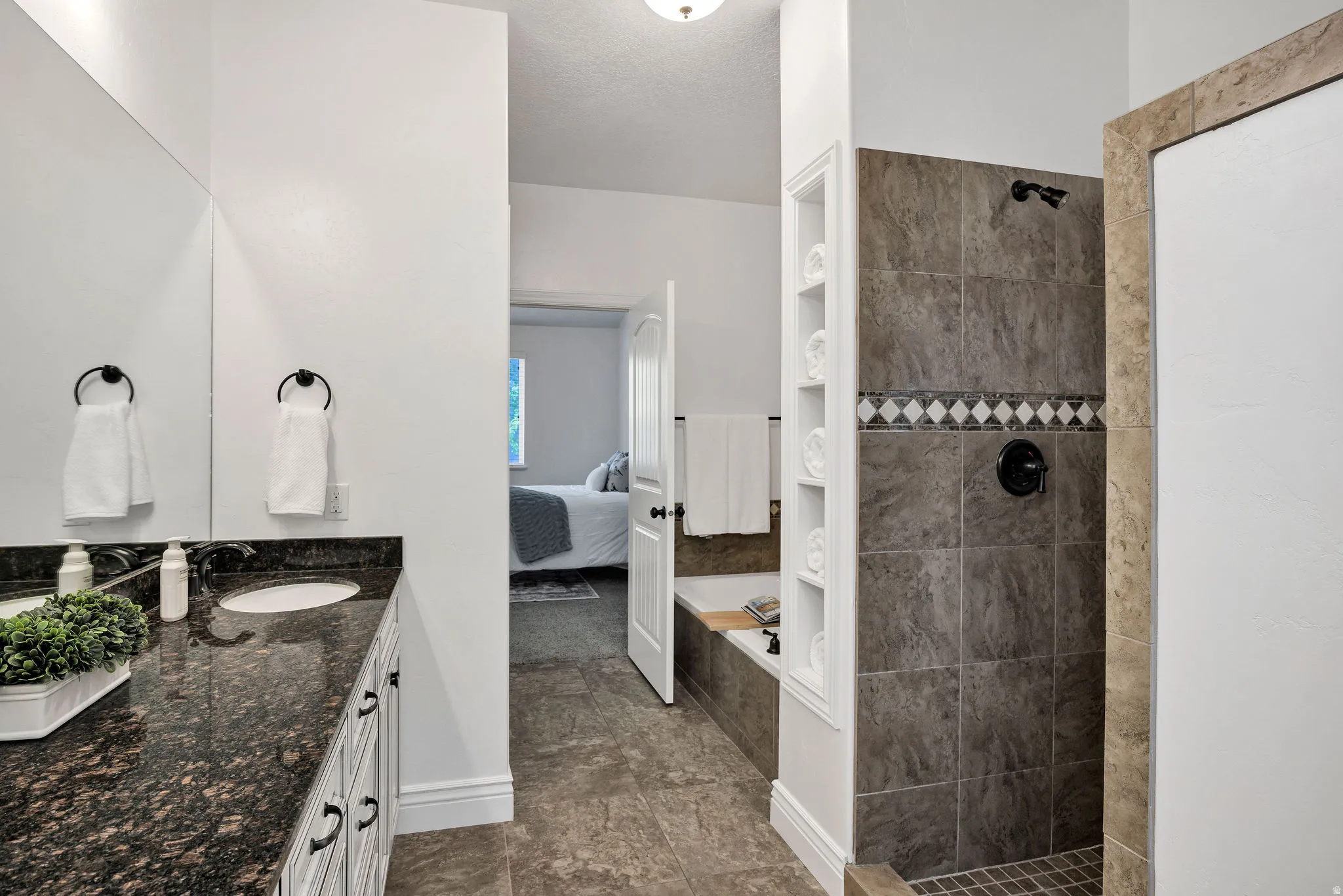 Ensuite bathroom with vanity, a bath, walk in shower
