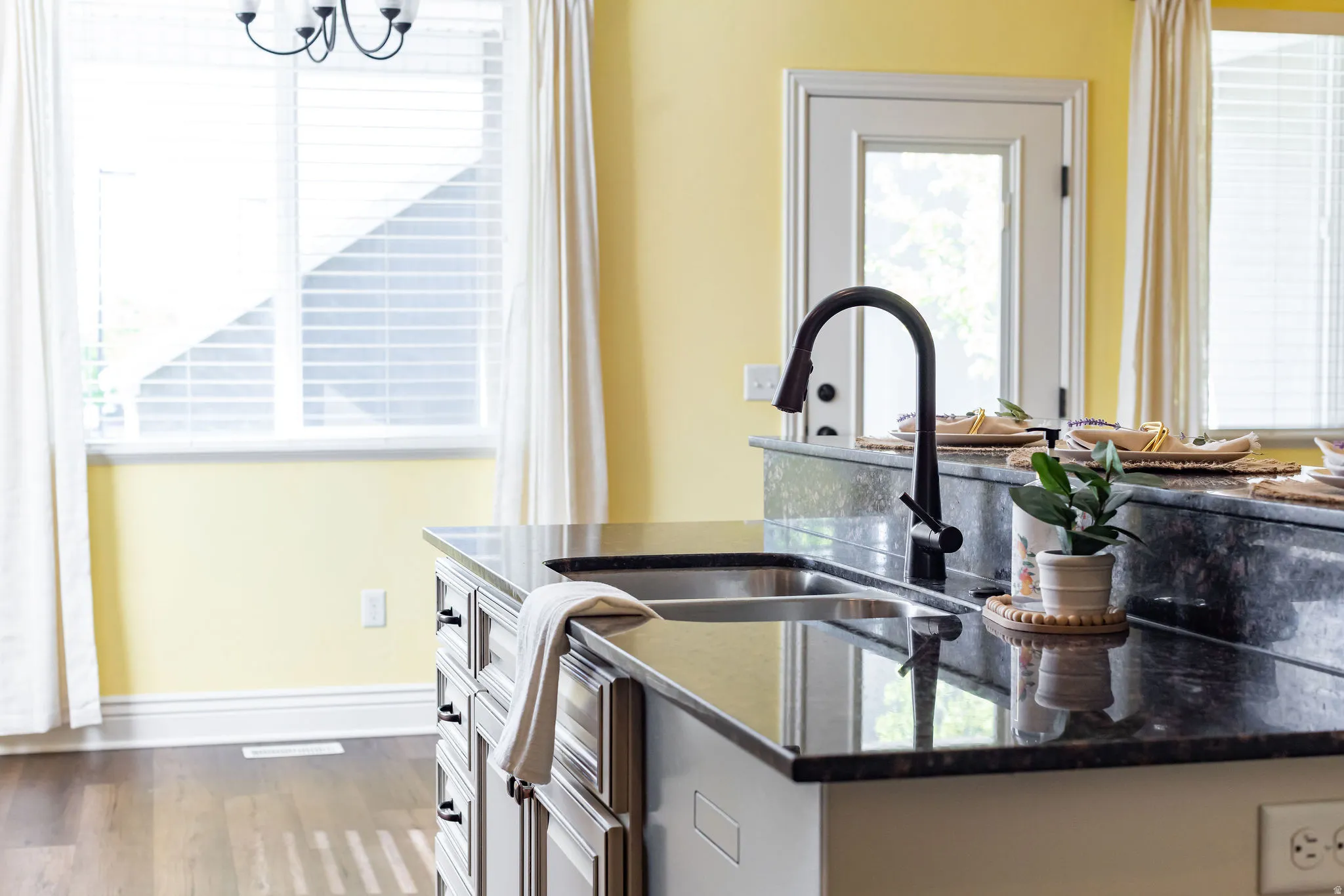 Kitchen featuring dark stone counters and dark wood finished floors