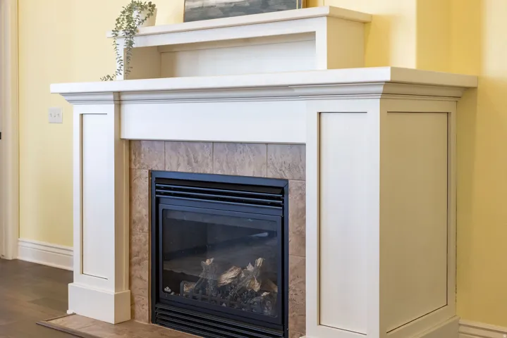 Detailed view of a tile fireplace and wood finished floors