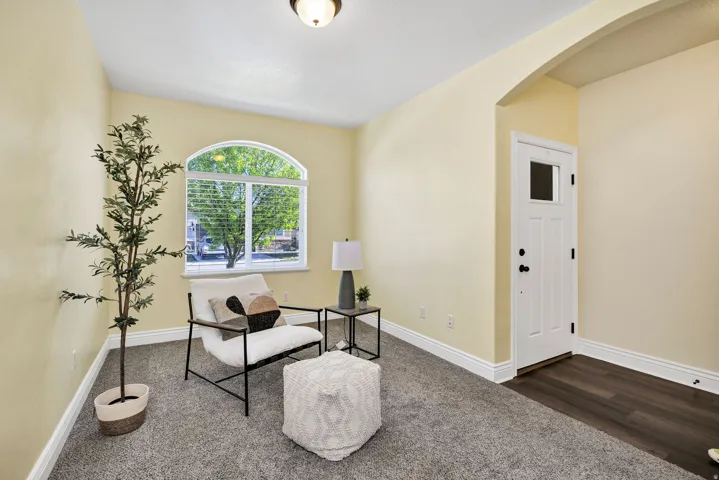 Front Living area with arched walkways and dark wood finished floors