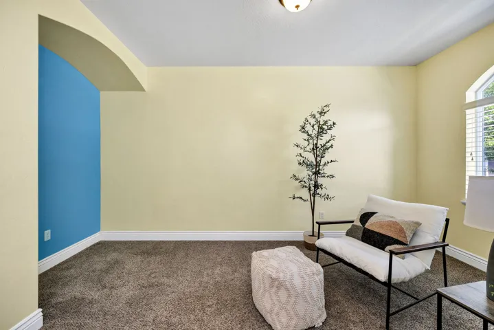 Front Living area featuring carpet flooring and arched walkways