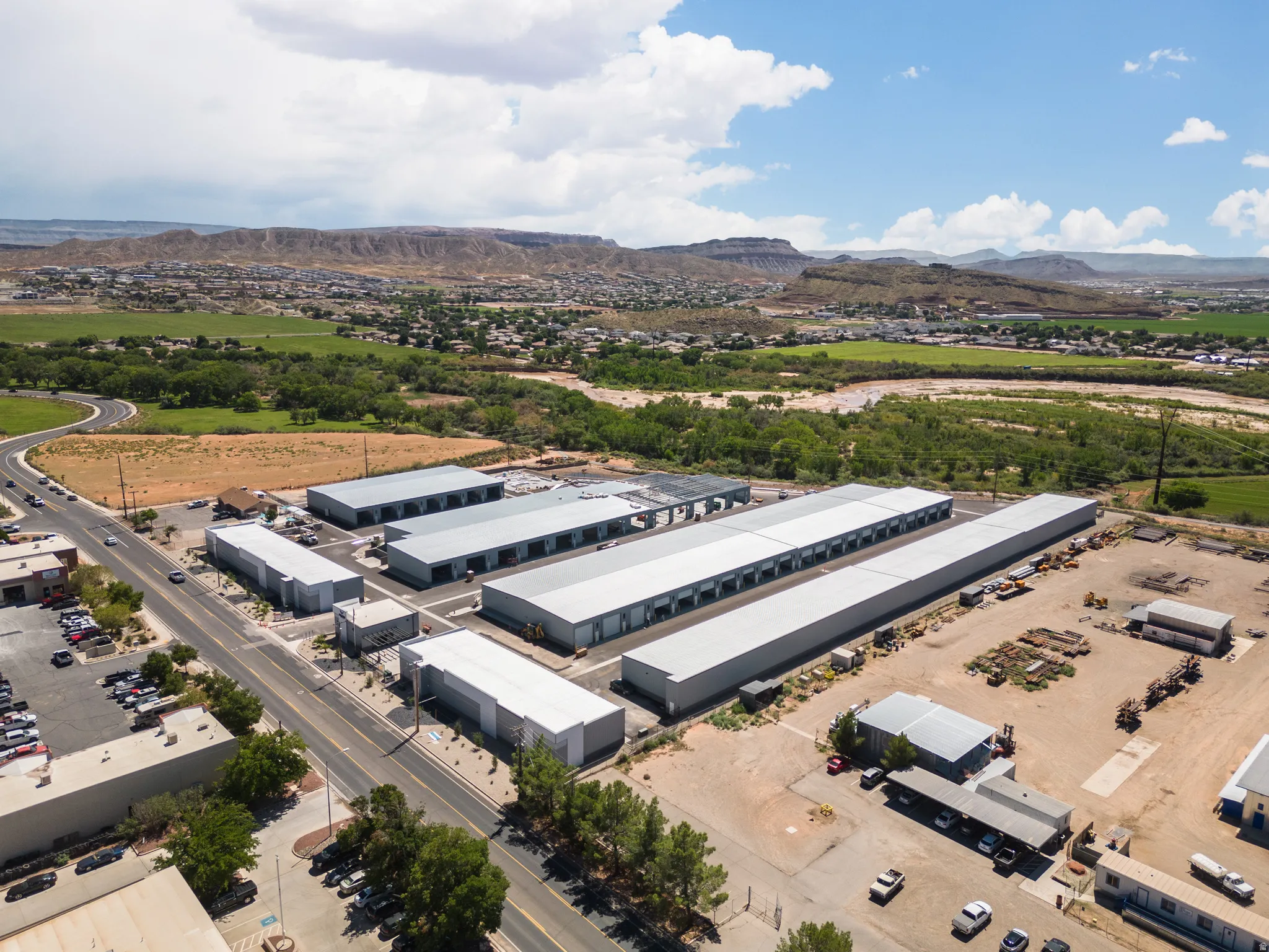 Aerial view of industrial structures and a mountainous background