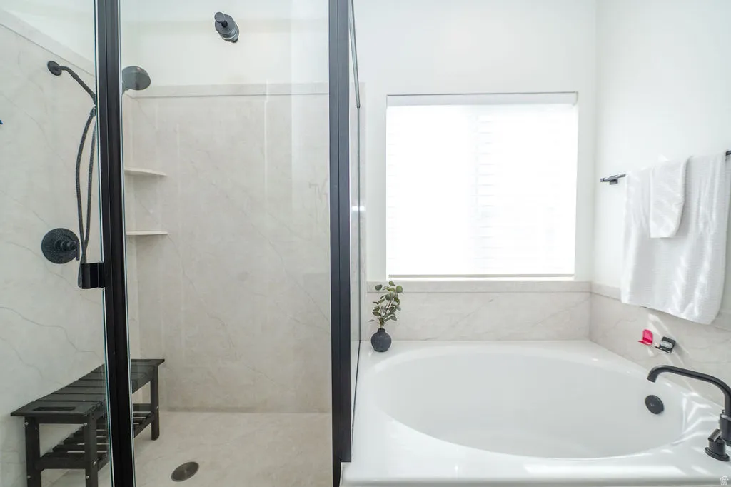 Bathroom featuring a shower stall and a garden tub
