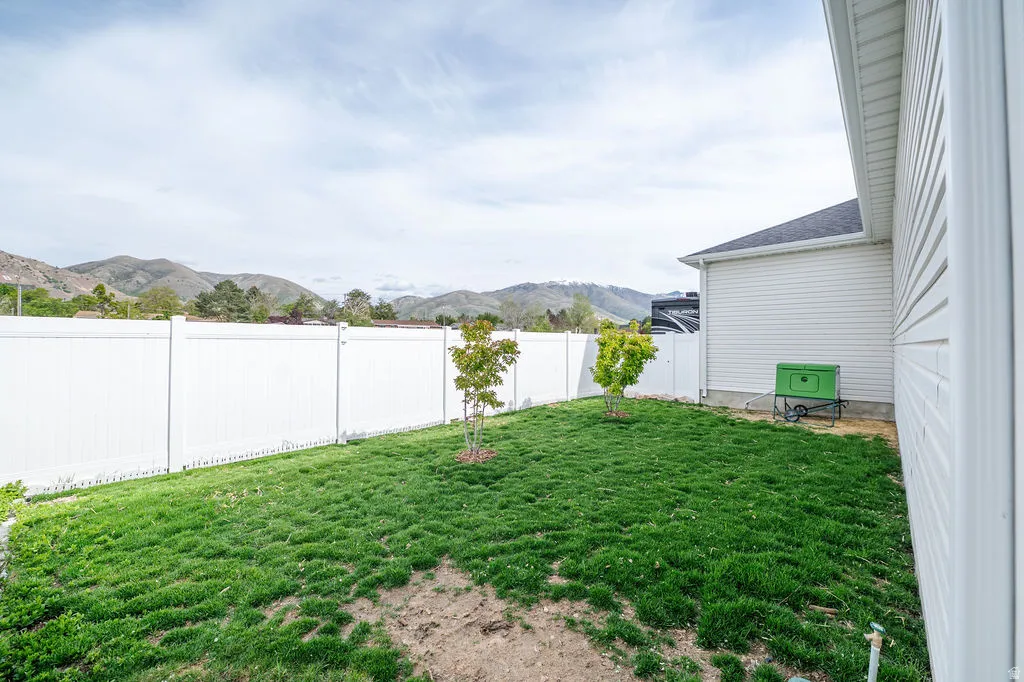 Fenced backyard with a mountain view