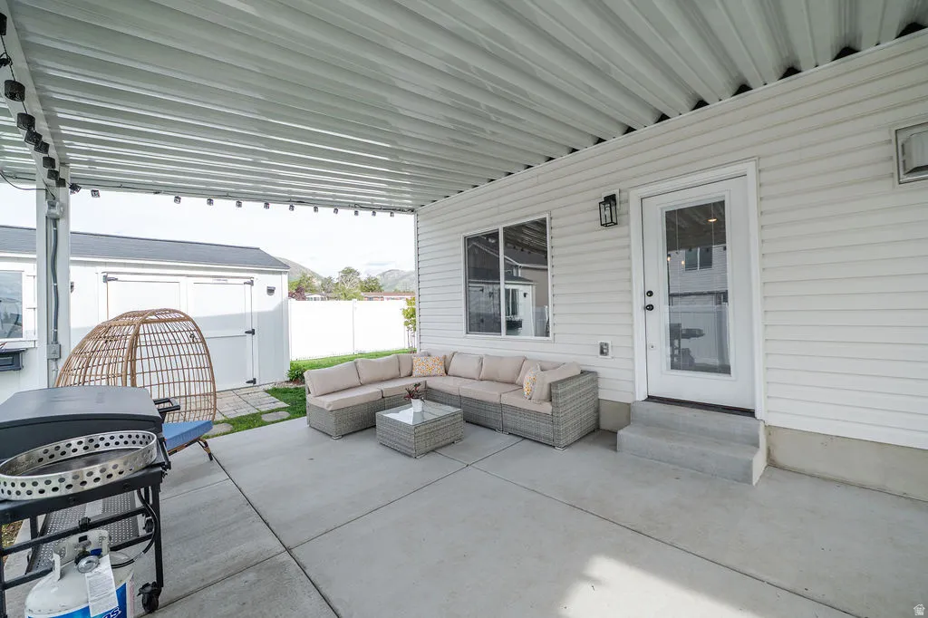 View of patio / terrace with a storage shed, grilling area, entry steps, and an outdoor hangout area