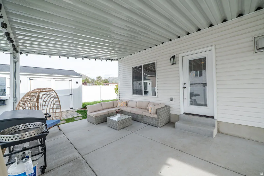 View of patio / terrace with a storage unit, a grill, entry steps, and outdoor seating