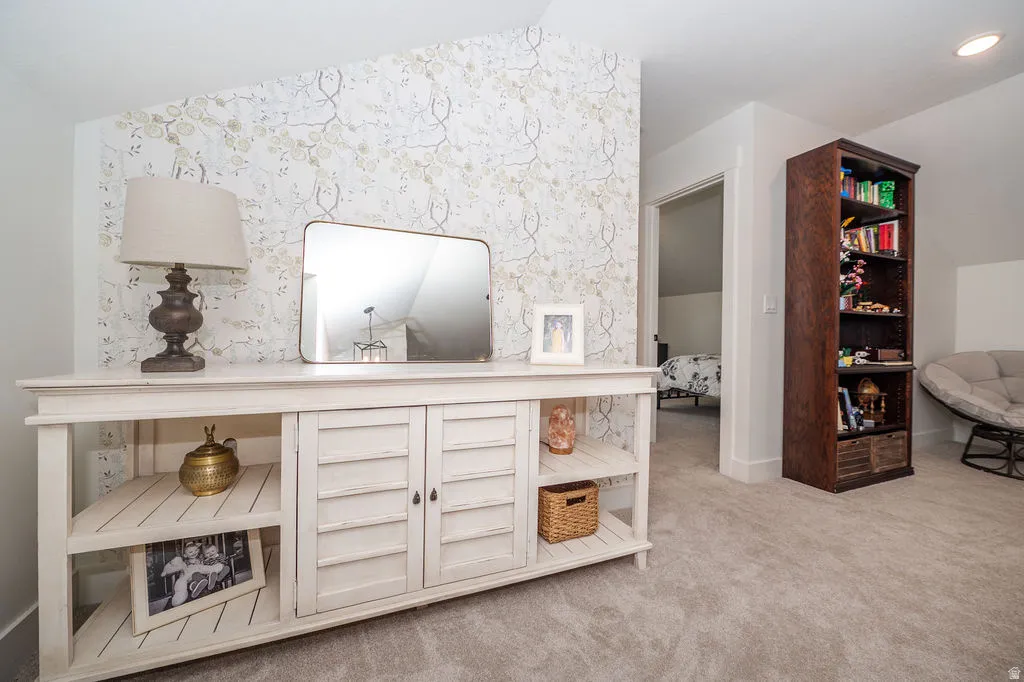Detailed view of carpet and wallpapered walls