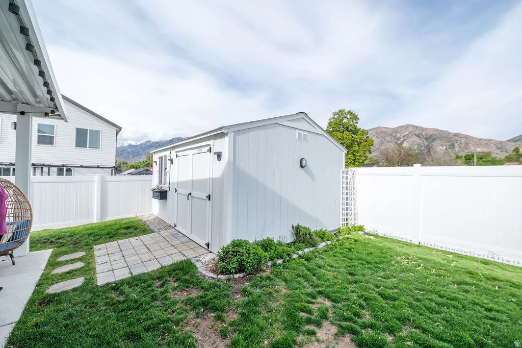 View of shed with a mountain view and a fenced backyard