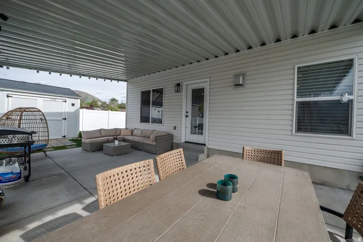 View of patio with outdoor lounge area and a shed