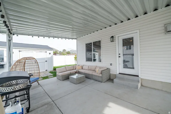 View of patio / terrace with a storage unit, a grill, entry steps, and outdoor seating