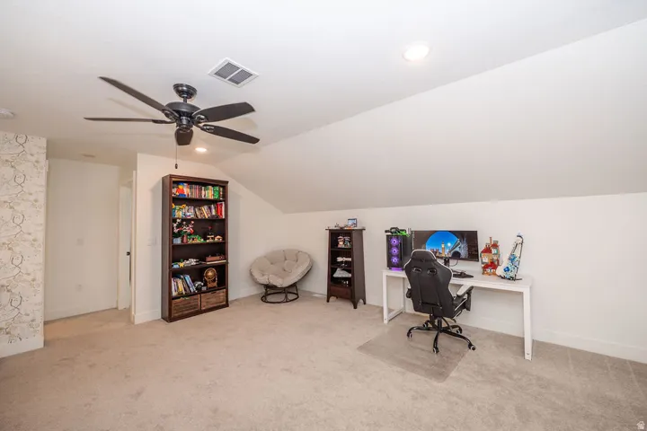 Office with lofted ceiling, light colored carpet, ceiling fan, and recessed lighting