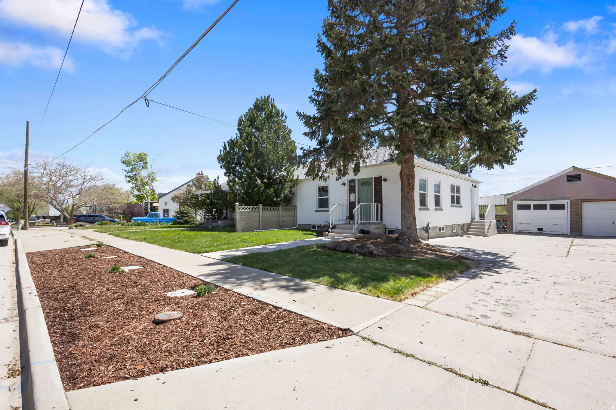 View of front of home featuring a detached garage and an outbuilding