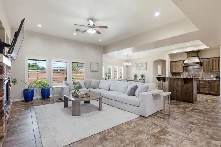 Spacious living area featuring high ceilings, recessed lighting, and a ceiling fan