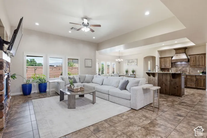 Spacious living area featuring high ceilings, recessed lighting, and a ceiling fan