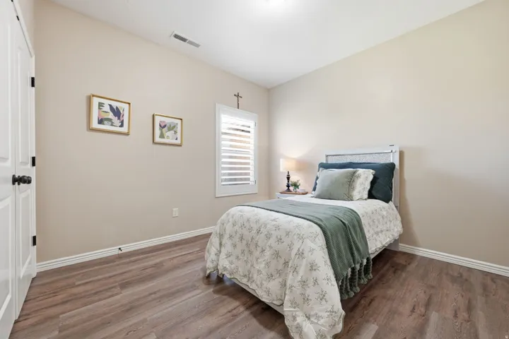 Room featuring wood-finish flooring, neutral wall tones, and white baseboards
