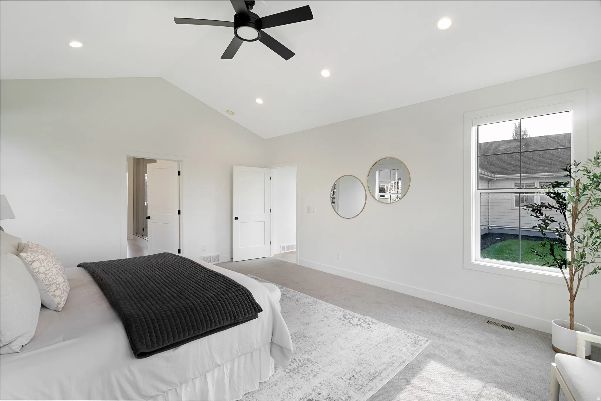 Bedroom featuring ceiling fan, recessed lighting, and a high ceiling