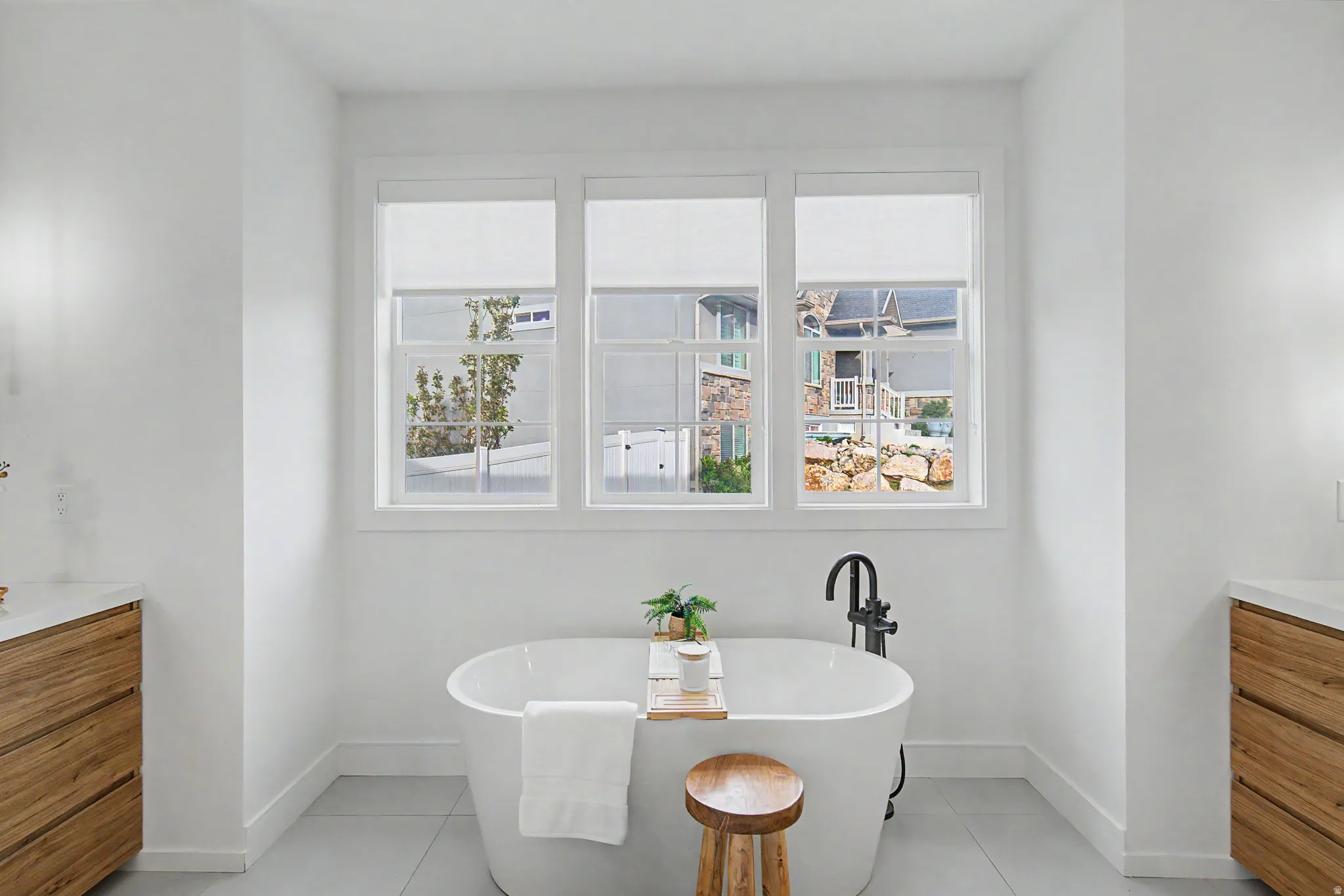 Full bathroom with vanity, a soaking tub, and light tile patterned floors