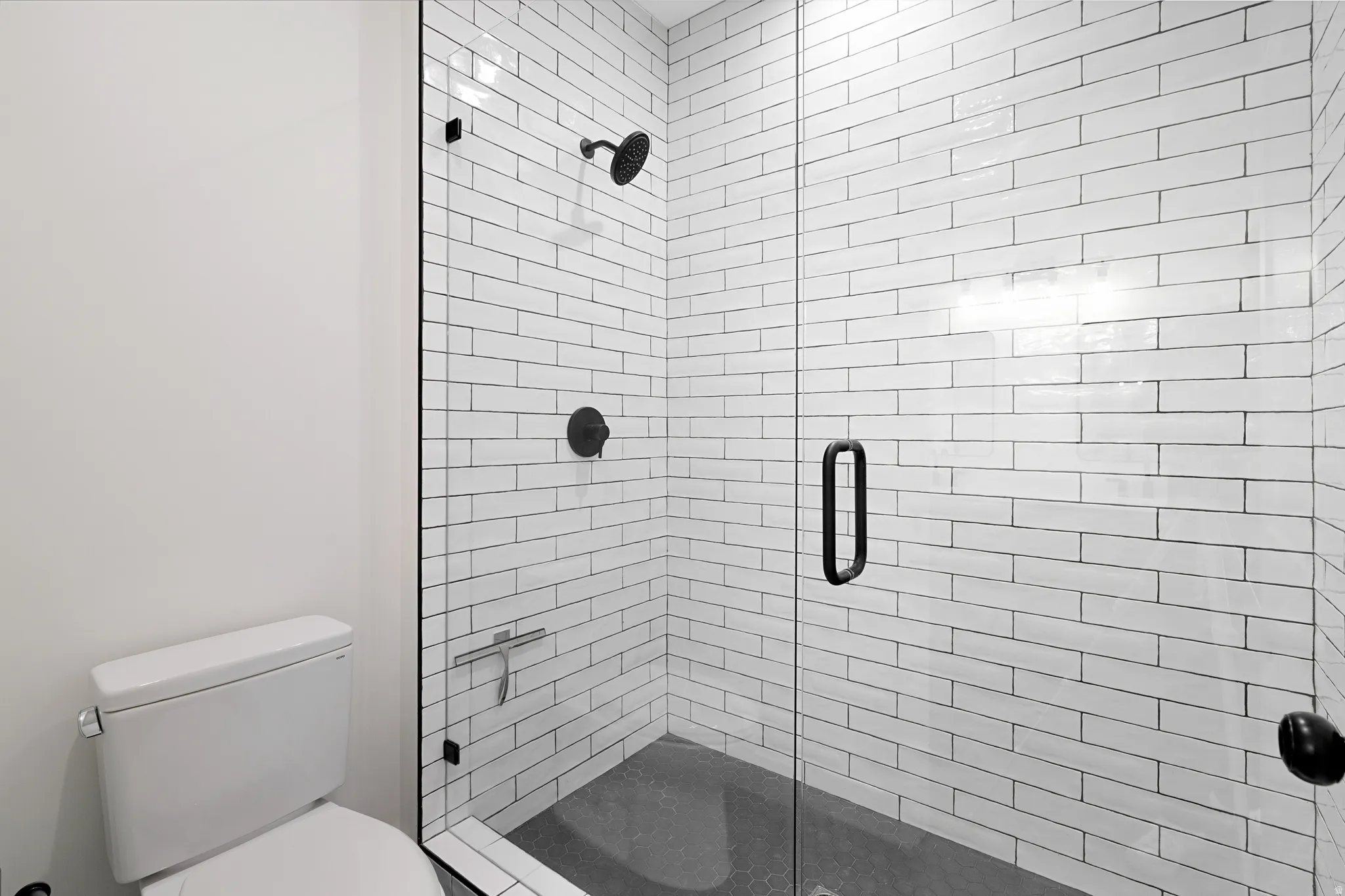 Bathroom with a stall shower and toilet