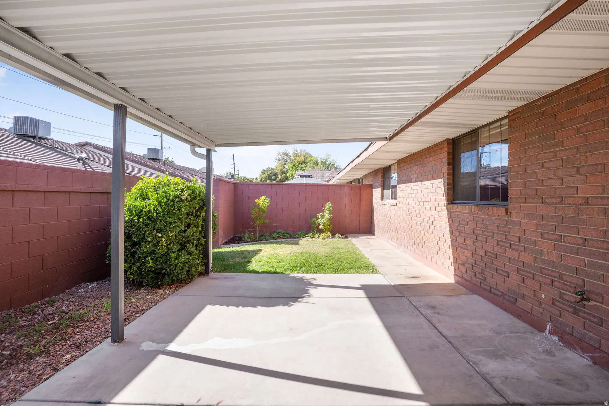 Fenced backyard featuring a patio