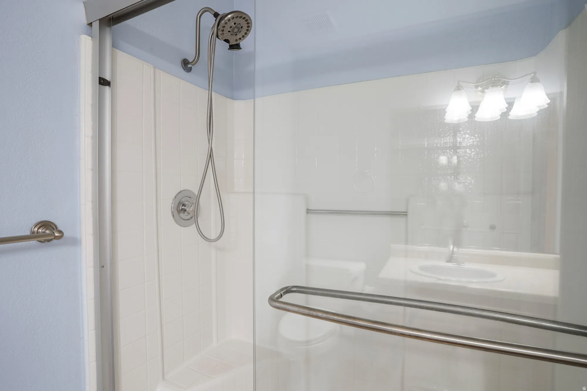 Full bath featuring a stall shower and a sink