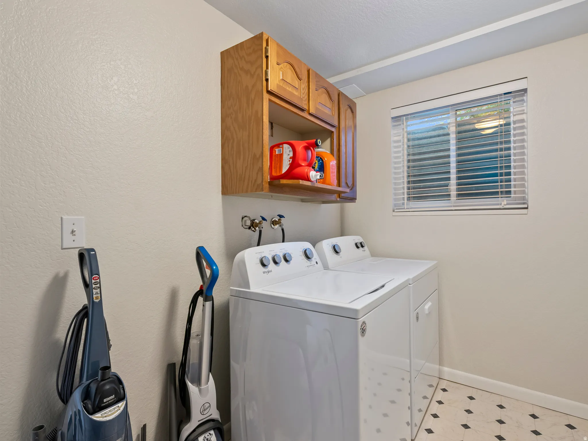 Laundry room with cabinet space and independent washer and dryer