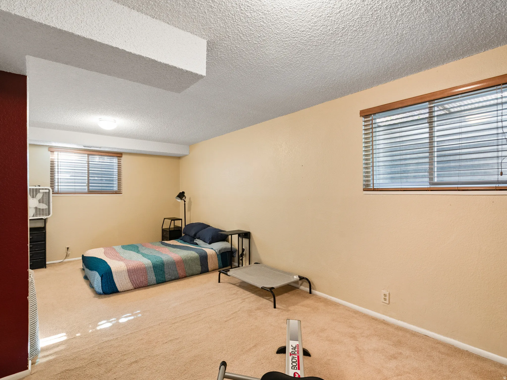 Bedroom with carpet flooring and a textured ceiling