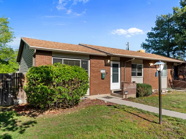 View of front of home with brick siding and a shingled roof