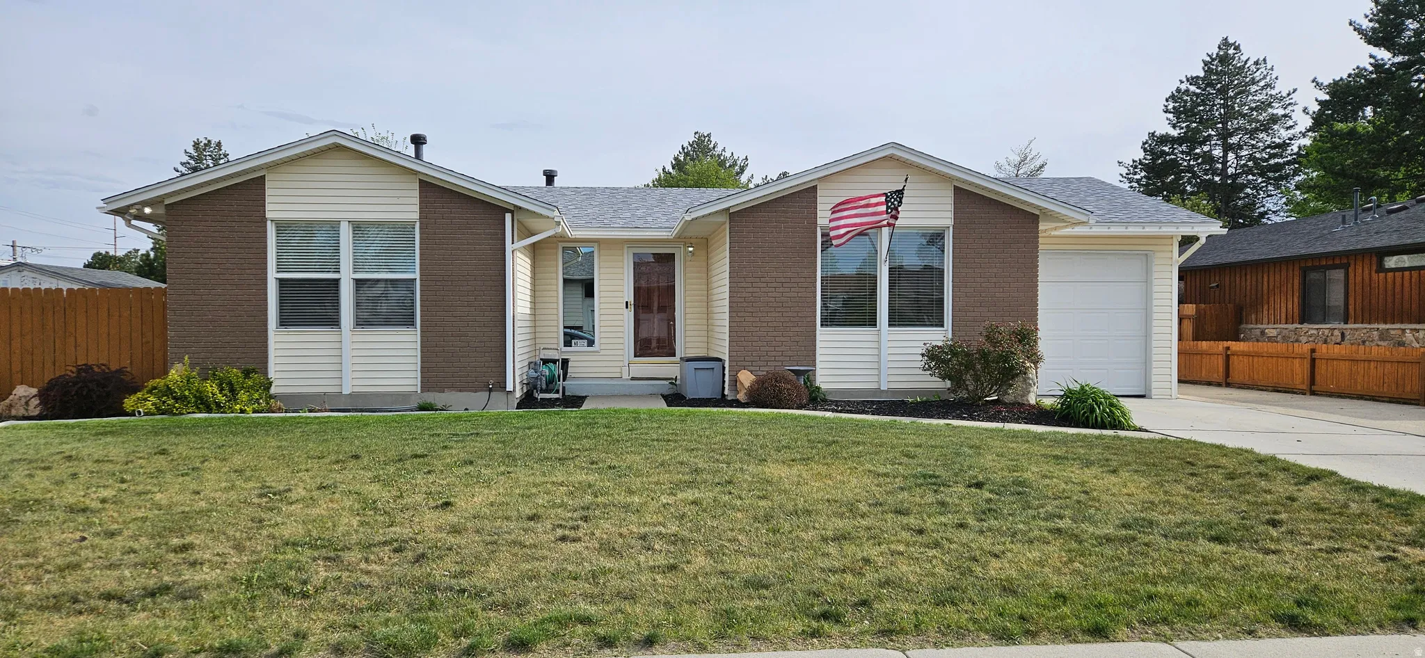 Ranch-style house featuring brick siding, a garage, concrete driveway, and a shingled roof