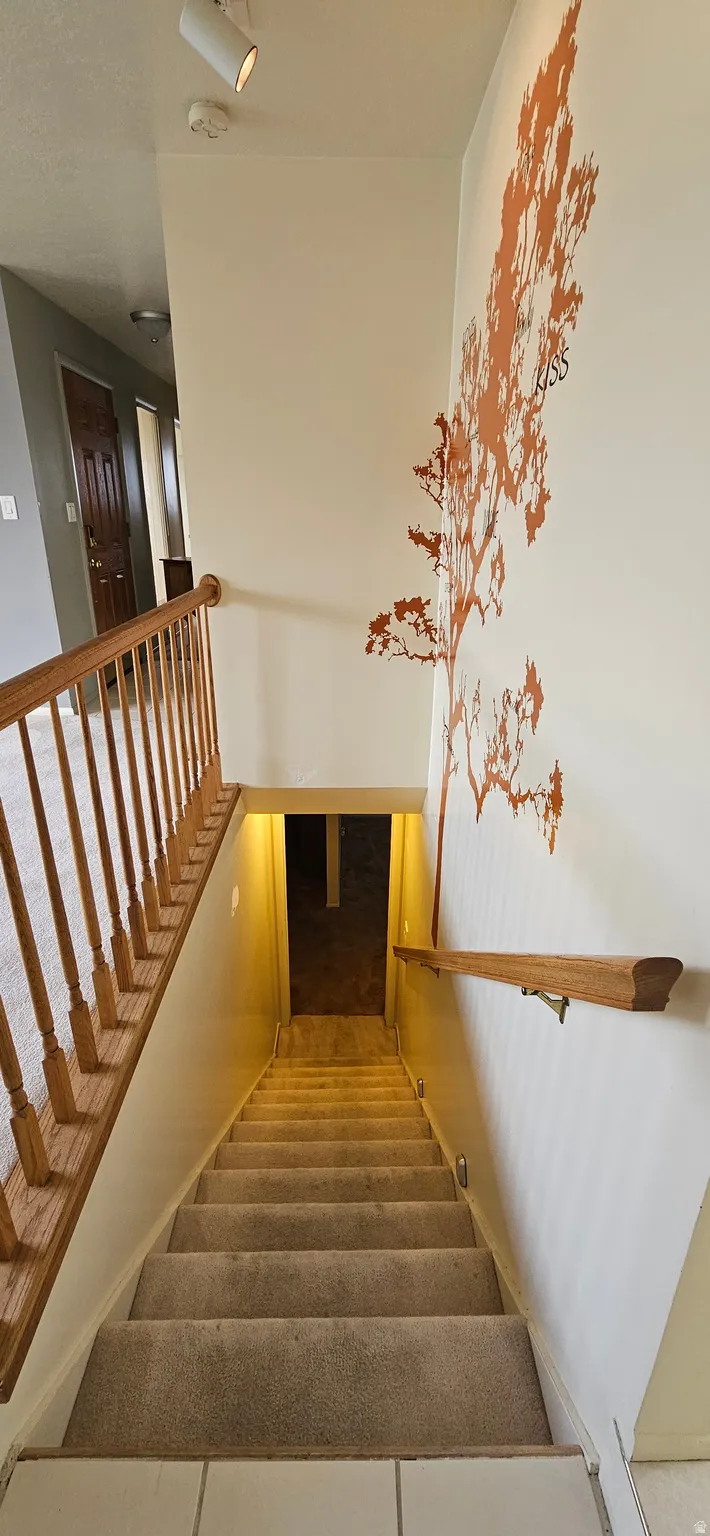 Staircase featuring tile patterned flooring
