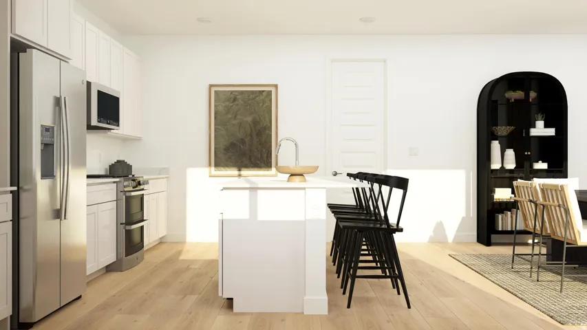 Kitchen featuring stainless steel appliances, a kitchen island with sink, white cabinetry, and light wood finished floors