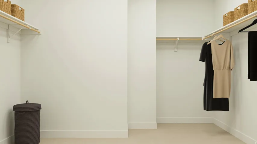 Walk in closet featuring light colored carpet