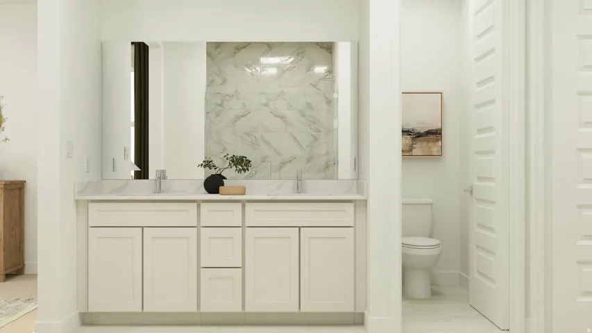Bathroom with double vanity and toilet