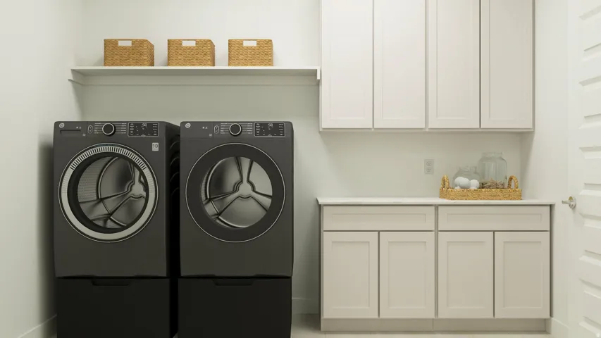 Laundry area featuring separate washer and dryer and cabinet space