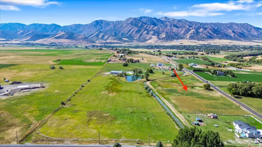 Overview of rural landscape with a water and mountain view and agricultural land