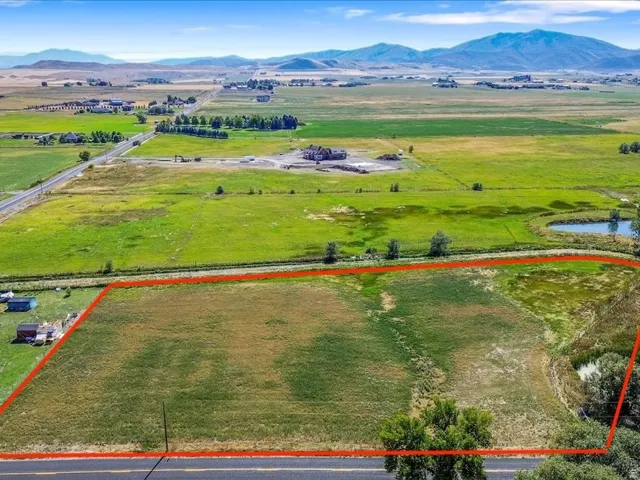 Overview of rural landscape with property boundaries highlighted and a water and mountain view