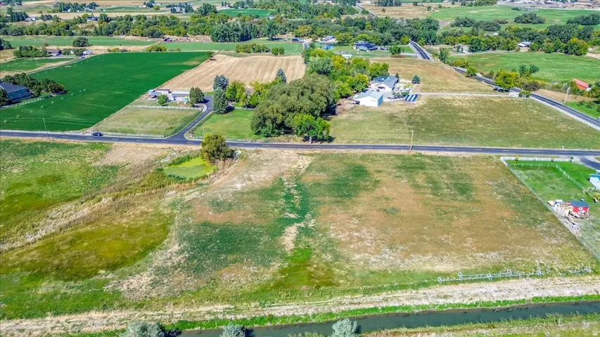 Aerial overview of property's location featuring rural landscape and rows of crops