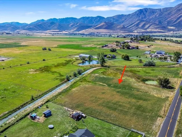 Overview of rural landscape featuring a water and mountain view