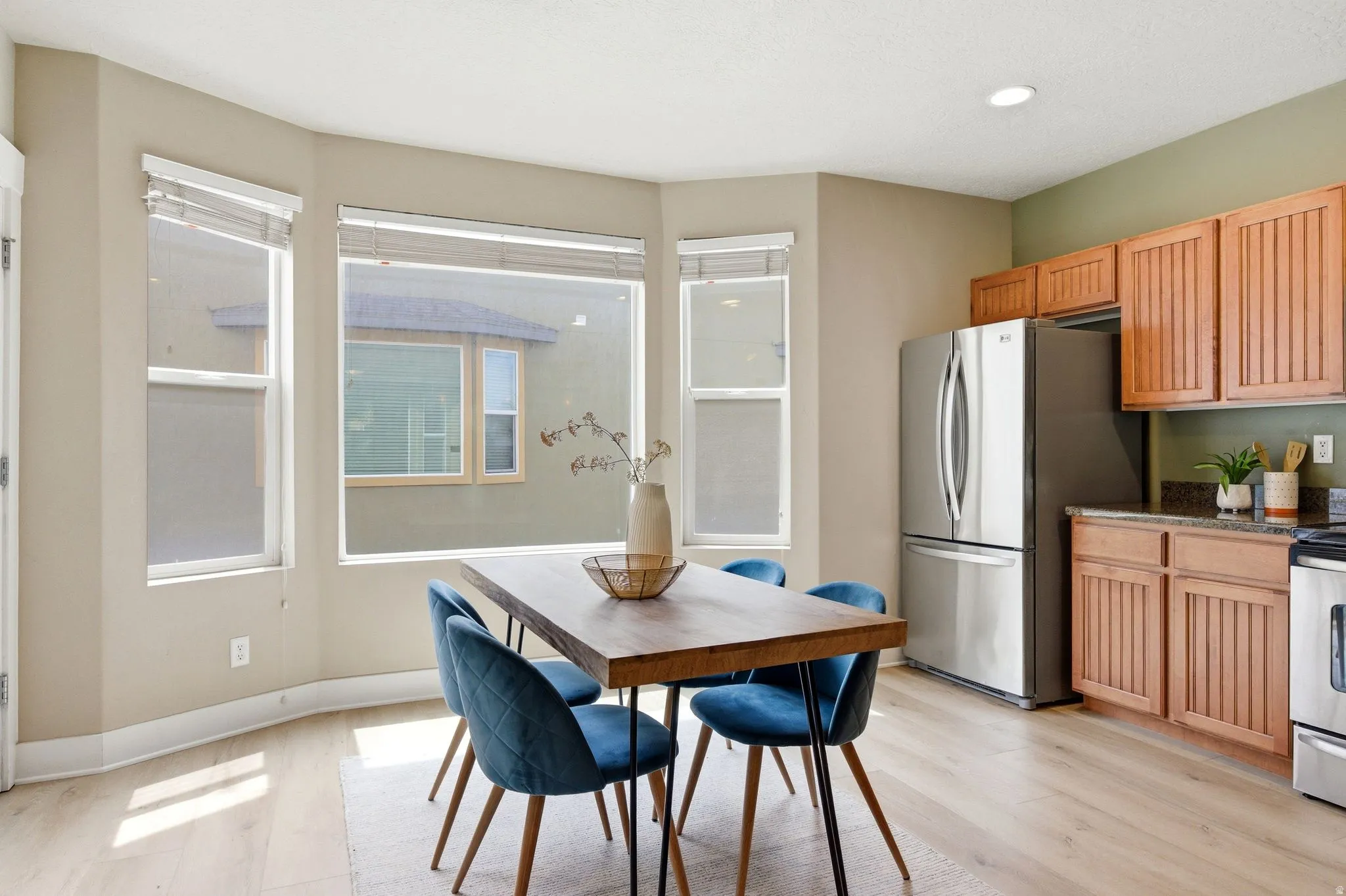 Dining area featuring light wood-type flooring and baseboards